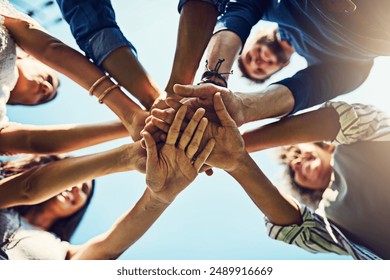 Hands, low angle and pile for team building with friends outdoor, support and solidarity in nature. Community, mission and partnership, trust and commitment with loyalty, group huddle and agreement - Powered by Shutterstock