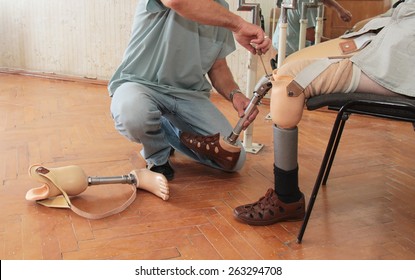 Hands Machinery Governing Prosthetic Leg On Man