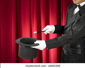 Hands Of The Magician With Magic Wand And Top Hat On Stage.