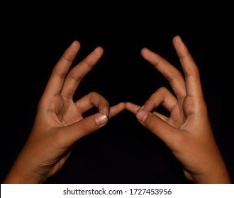 Hands In Maha Sacral Mudra Isolated On Black Background.