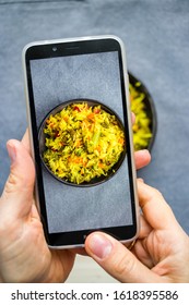 Hands Make Photo Of Food With Smartphone. Phone Photography Of Indian Basmati Rice For Blogging In Trendy Social Media Style