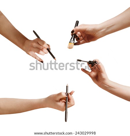 hands with a makeup brushes and pencils, isolated on white