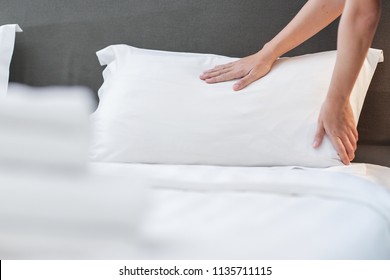 Hands Making Bed from Hotel Room Service - Shutterstock ID 1135711115