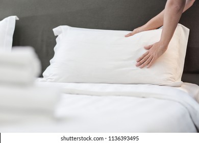 Hands Making Bed from Hotel Room Service - Shutterstock ID 1136393495