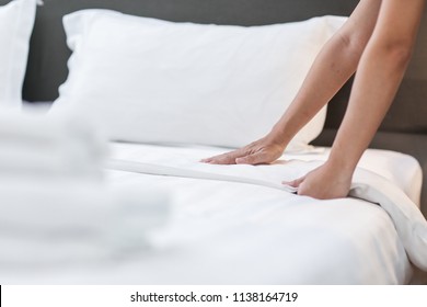 Hands Making Bed from Hotel Room Service - Shutterstock ID 1138164719
