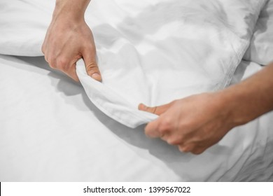 Hands Making Bed from Hotel Room Service