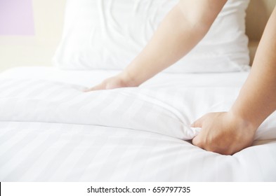 Hands Making Bed from Hotel Room Service - Shutterstock ID 659797735