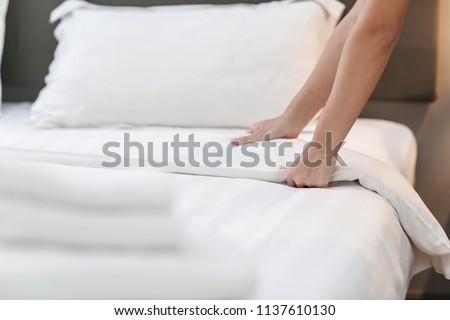 Hands Making Bed from Hotel Room Service