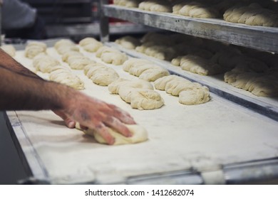 Hands making bread pastery in industry