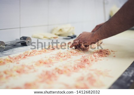 Hands making bread pastery in industry