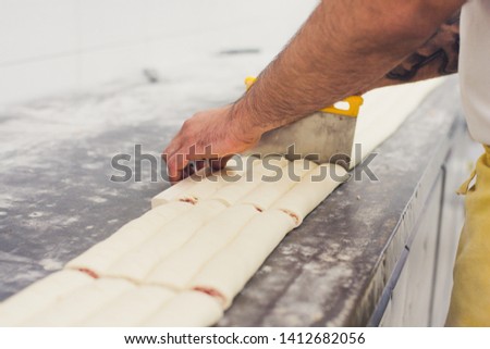 Hands making bread pastery in industry