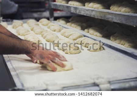 Hands making bread pastery in industry