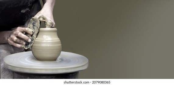 Hands making ceramic cup on potter's wheel with copy space - Powered by Shutterstock