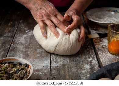 Hands making dough on the wood backgorund 