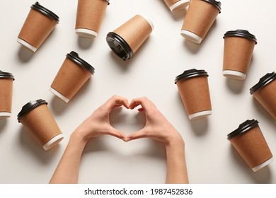 Hands Making Heart And Many Takeaway Cups For Drink On Light Background