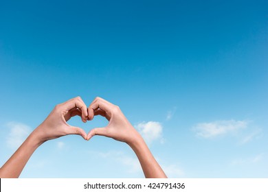 Hands Making A Heart Shape In The Blue Sky