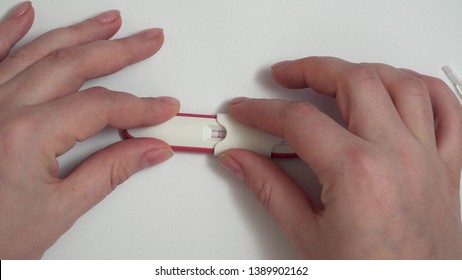 Hands making a pregnancy test, positive result - Shutterstock ID 1389902162