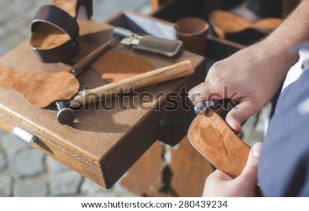 Hands making shoes. Shoemaker
