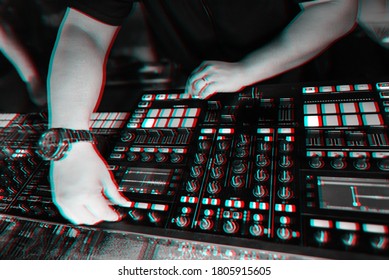 Hands Of A Male DJ On The Background Of Music Professional Equipment For Mixing Music. Black And White Photo With Virtual Reality Glitch Effect