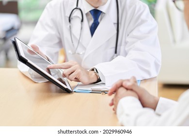 Hands Of A Male Doctor Explaining To The Elderly