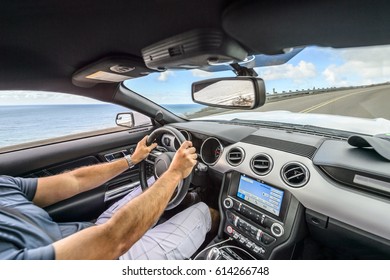 Hands Of A Male Driver On A Steering Wheel Driving Through The Mountains On A Scenic California Coast Road