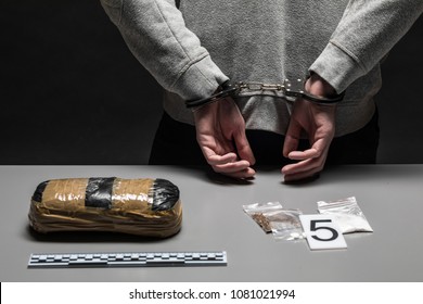 Hands Of A Male Drug Dealer Are Handcuffed. The Fight Against Drugs And Crime.