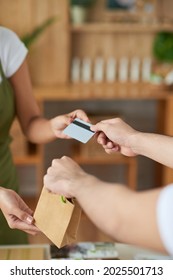 Hands Of Man Buying Handmade Soap In Offline Store And Paying With Credit Card