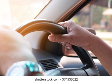 Hands Of A Man With Car Steering Wheel Is Ready On The Move In The Modern Life Style.