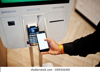 Hands Of Man Customer At Store Place Orders And Pay By Contactless Credit Card On Mobile Phone Through Self Pay Floor Kiosk For Fast Food, Payment Terminal. Pay Pass.