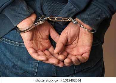 Hands of man and handcuffs
