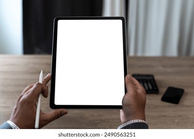 hands of a man holding blank tablet a mockup. iPad digital tablet workspace table - Powered by Shutterstock