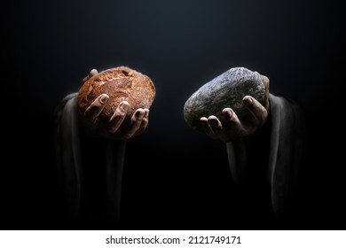 Hands Of A Man Holding A Stone And A Bread. Religious Biblical Theme Concept.