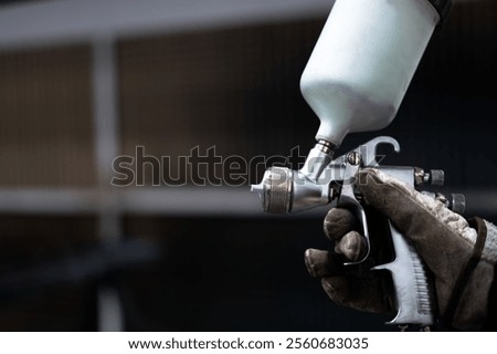 hands of a man with a paint gun