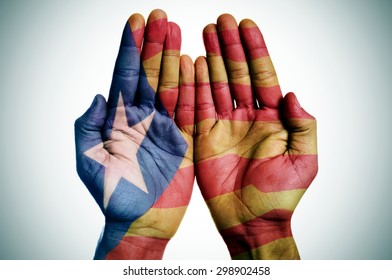 the hands of a man patterned with the Estelada, the Catalan pro-independence flag