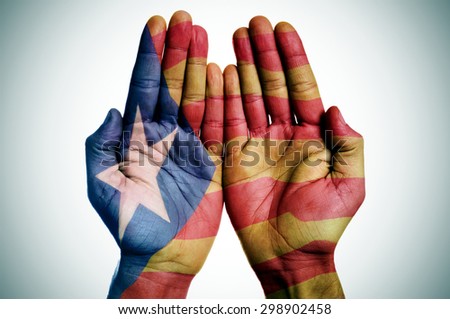 the hands of a man patterned with the Estelada, the Catalan pro-independence flag