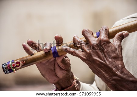 Hands of a man playing a flute / Perfect hands / the magic sound of India