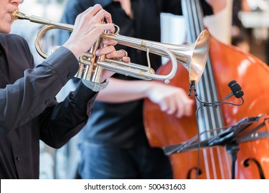 Hands of the man playing the trumpet
