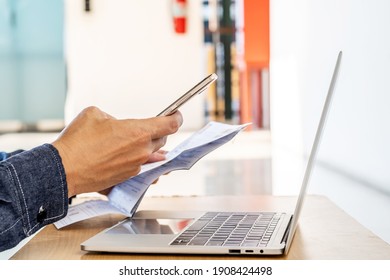 Hands Of Man Using Mobile Smart Phone Payment Online With Family Budget Cost Bills On Desk, Plan Money Cost Saving, Investment, Business Finance, Expenses Concept