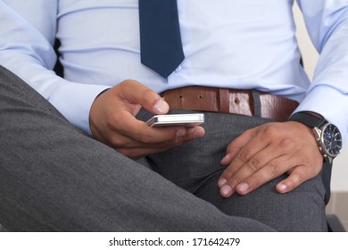 Hands of a man using a smartphone.
