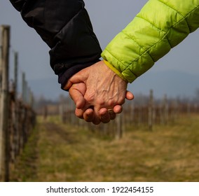 Hands of a man and a woman crossed. A man and a woman on a winter vignette. Hands of two old people.