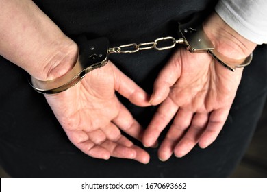 hands of man and woman in handcuffs - Shutterstock ID 1670693662