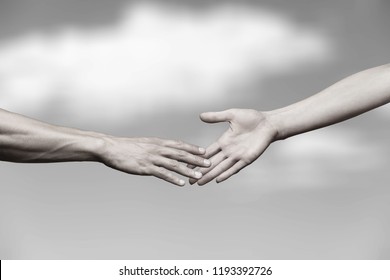 Hands Of Man And Woman Reaching To