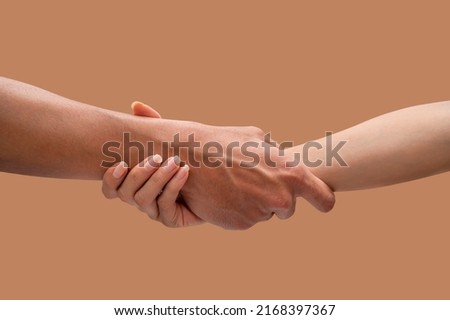 Hands of a man and woman at the time of rescue, isolated on brown backgrounds, Concept of salvation. 