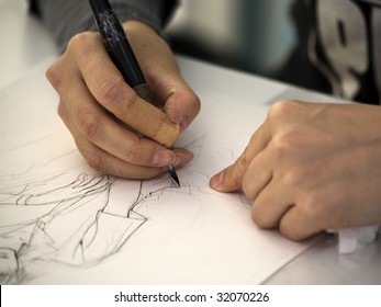 Hands Of A Manga Artist Drawing A Sketch