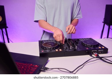 Hands manipulating digital DJ controller deck, green stage lighting, tactile jog wheel, precision mixing, energetic performance vibe, content creator or club DJ