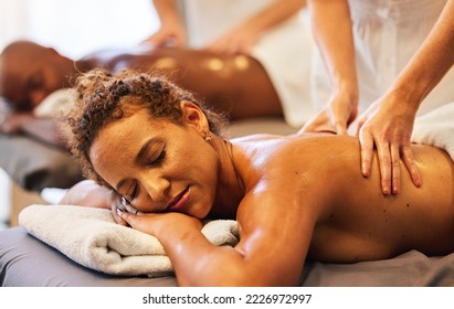 Hands, massage and relax with a couple in a spa, lying on a table for wellness or luxury at a resort. Skin, bed and therapy with a man and woman in a beauty center for zen on holiday or vacation - Powered by Shutterstock