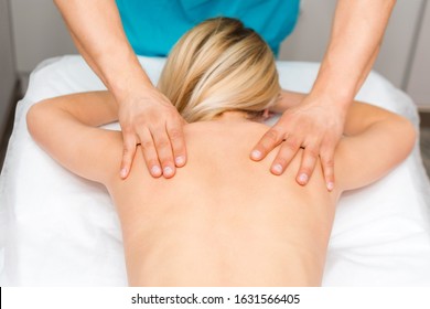 Hands of a massage therapist doing back massage of a woman. Young woman having body sculpting procedure. Chiropractic back adjustment. Osteopathy, alternative medicine, pain relief concept. - Powered by Shutterstock