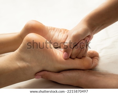 Hands of the masseur doing massage on the soles of the feet,close up