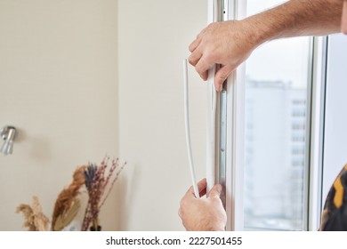 the hands of the master replace the rubber bands on the plastic window.