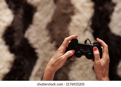 Hands Of Mature Woman Enjoying Playing Videogame At Home